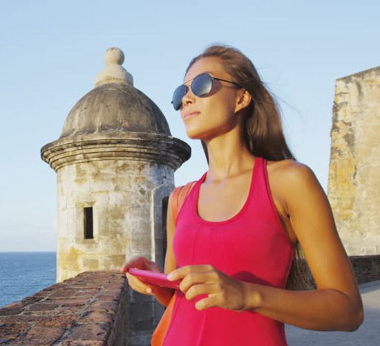 Tourist woman enjoying her walking tour at al Morro Castle